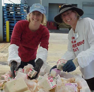 Photo of County employees sorting through a bin of trash.